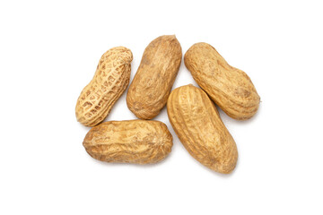 Dry roasted whole peanut pods on white background