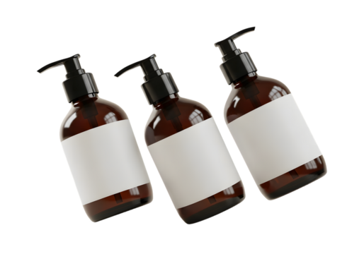 Three amber bottles with pump dispensers and blank labels against black backdrop
