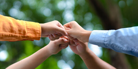 Close-up of people colliding in a circle to be environmentally friendly.