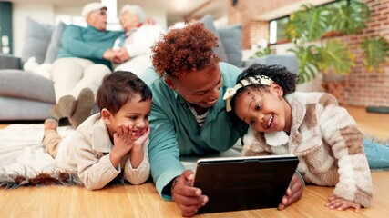 Bonding, love and tablet with family on floor in living room of home for break or streaming. App, relax or watching video with father and sibling children in apartment for subscription entertainment - Powered by Adobe