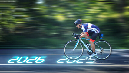 Determined cyclist on roadmap to 2026 showing future goals and fast progress on an outdoor road with motion blur