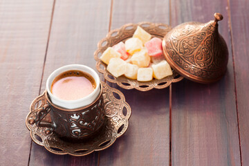 Traditional turkish coffee and turkish delight on  wooden table.
