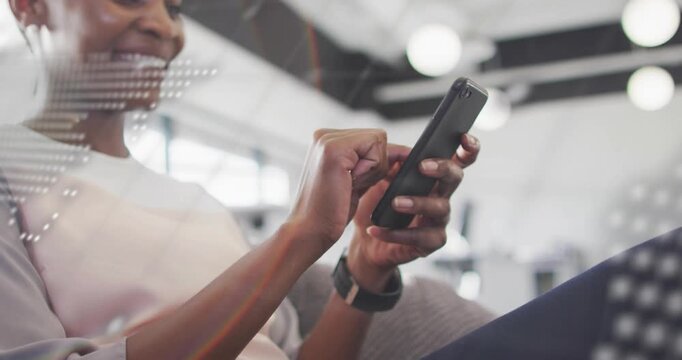 Woman tapping smartphone screen in lounge, causing dotted map and scrolling code showing tech data