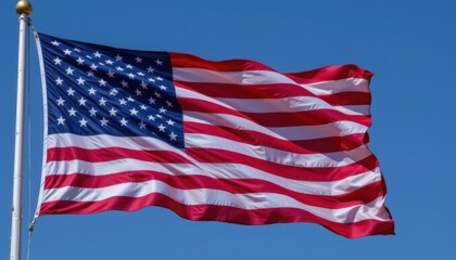 American Flag Waving Against Clear Blue Sky Symbolizing Patriotism and National Pride