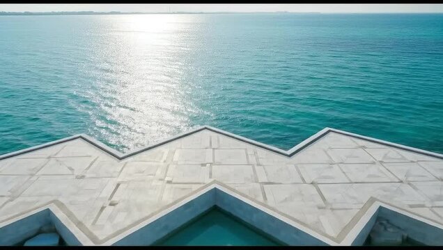 An aerial view of the national museum of qatars unique architecture, showcasing its geometric design and tranquil turquoise waters