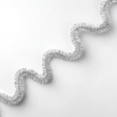 Elegant shiny silver garland in soft loops on a minimalist white background, perfect for holiday decor and festive celebrations