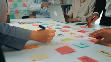 A modern office scene featuring a diverse group of professionals engaged in a collaborative business meeting. Colorful sticky notes spread across the table enhance brainstorming efforts. SACTR - Powered by Adobe