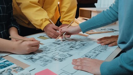 A dynamic team collaborates around a table filled with architectural plans, sketches, and colorful notes, highlighting creativity and cooperation in project development. SACTR