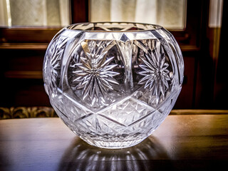 Cut Crystal Vase Illustration – Geometric Starburst Etching on Wood Surface with Elegant Ambient Light