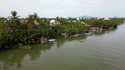 Obraz premium Asia, Vietnam , Hoi An Daily life flows slowly on the Thu Bon River with fishing boats with nets and trawlers - Hoi An the city of lanterns, a UNESCO World Heritage Site