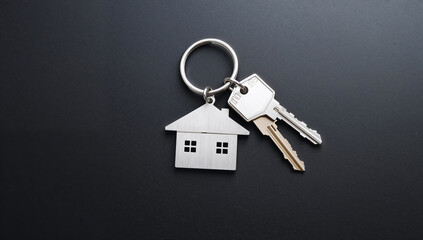 House keys on a keyring with a house-shaped keychain