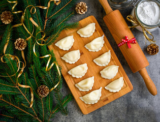 Christmas dumplings with decoration on a wooden board. Top view.
