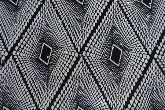 Top view of black and white fabric with geometric pattern and sequins - Powered by Adobe