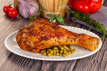 Baked turkey drumstick served green peas