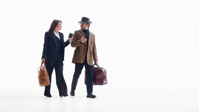 Business colleagues walking together with travel bags and positive mood. Concept of teamwork visuals, corporate mobility, HR communication, partnership and travel marketing.