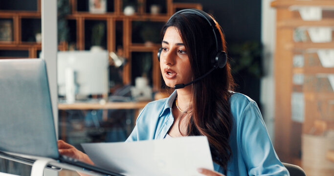 Woman, headset and laptop with communication, documents and review for solution at media company. Person, consultant and virtual meeting with computer, problem solving and voip mic at creative agency