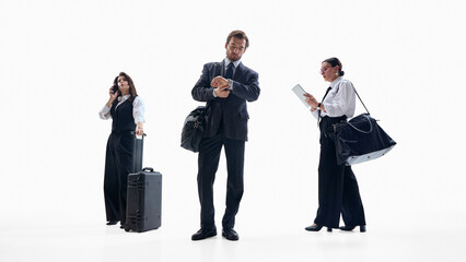Diverse business team waiting with luggage and digital devices. Concept of corporate mobility workflows, travel communication, HR visuals, team coordination content.