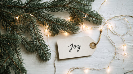 Evergreen branches with soft lights and a joy tag create a warm, inviting atmosphere for the Christmas holidays