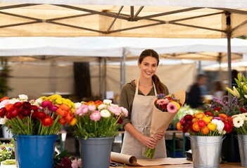 flower vendor in apron selling colorful bouquets at local farmers market