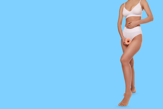 A person cradles a flower, showcasing self-care