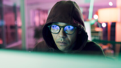 Night, hacking or man with computer for encryption breach, firewall attack or cybersecurity crisis. Confidential info, system access or it programmer in dark data center, tech reflection or spyware