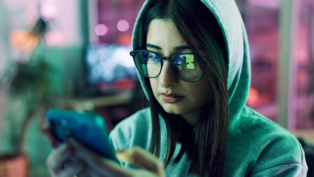 Night, hacker and woman with smartphone, glasses and online reading with cybersecurity programming. Person, reflection or programmer with cellphone, website server and eyewear with coding and privacy
