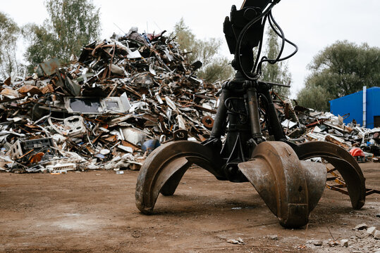 Industrial Scrap Yard with Hydraulic Grab Machine at Work