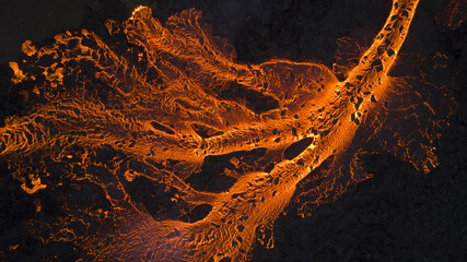 Aerial view of molten lava flowing with intense heat, contrasting sharply against the dark landscape, Reykjanes, Grindavikurber, Iceland.