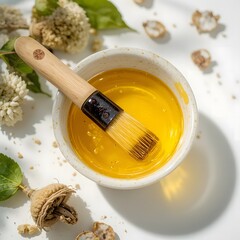 “Amla Oil in Bowl with Applicator on White Background”. amla oil