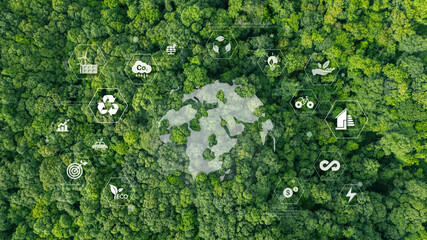 Global environment, ecology and sustainability concept with eco symbols representing renewable energy, recycling, carbon reduction and eco-friendly green business. High angle view of green background.