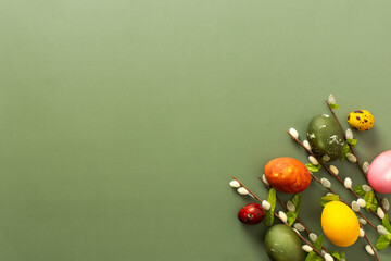 Brightly colored Easter eggs are displayed alongside spring branches, evoking a cheerful atmosphere perfect for the holiday. This festive arrangement celebrates seasonal joy and renewal