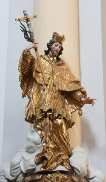 SALZBURG, AUSTRIA - SEPTEMBER 6, 2025: The carved polychrome baroque staue of St. John of Nepomuk in the church Pfarrkirche M&uuml;lln by unknown baroque artist from (cca 1600). 