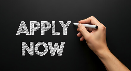 Hand writing apply now on black background, symbolizing opportunity, urgency, and the call to action for immediate application