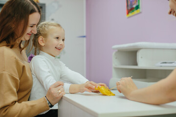 Mother and child smiling during pediatric clinic visit