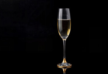 Champagne Glass with Golden Bubbles on Black Background