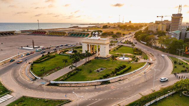 Aerial view of the iconic Independence Arch standing proudly amidst the circular roads and lush greenery, Accra, Greater Accra Region, Ghana.