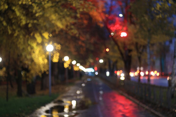Evening in an autumn park, abstract blurred background, changing seasons in the city