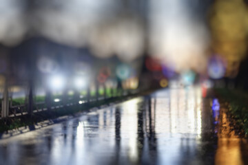 Night city blurred background, bokeh in autumn city traffic cars