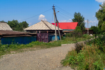 One of the city streets. Old private houses. Country street. No asphalt. Blue sky and Green trees. Summer. Ust-Kamenogorsk (kazakhstan)