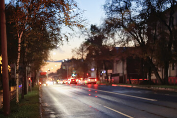 Night city blurred background, bokeh in autumn city traffic cars