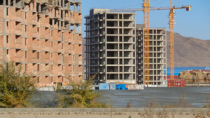 Modern apartment buildings under construction. Architectural background. Construction cranes. Contemporary architecture. Ust-Kamenogorsk (kazakhstan)