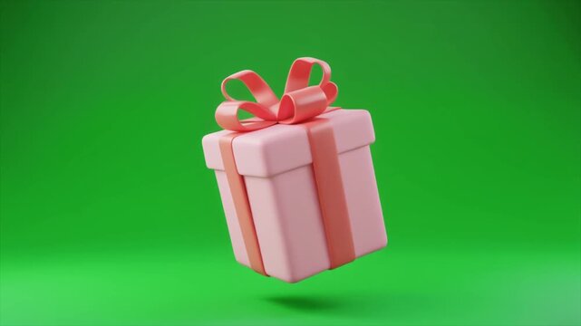 A charming pink gift box with a delicate ribbon and bow floating against a vibrant green studio background.