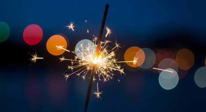 Festive sparkler with blurred bokeh lights for a celebratory background
