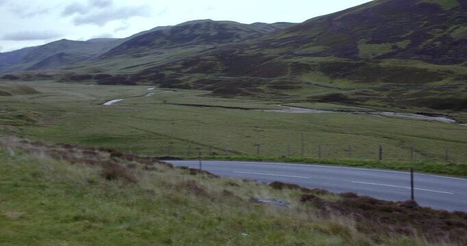 wide right to left panning shot Looking up the A93 old military Rd to braemar at Glenshee