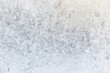 white winter background, frosty patterns on glass, abstract backdrop of ice and snow crystals in a blur