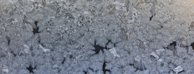 ice pattern on winter glass, abstract background on a cold sunny day