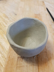 Rustic Clay Bowl: Handmade Pottery Art on Wood