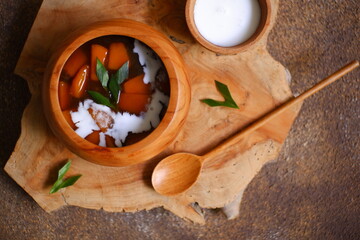 Sweet potato and coconut milk on wooden background