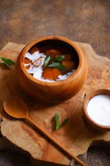bowl of tapioca porridge or jenang pati in Bahasa against wooden background 