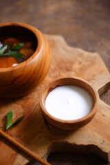 bowl of coconut sauce in a wooden bowl
